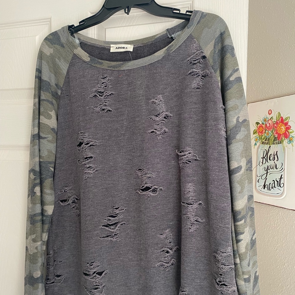 Gray boat neck shirt with camo sleeves.  Thread bare look on front/back.